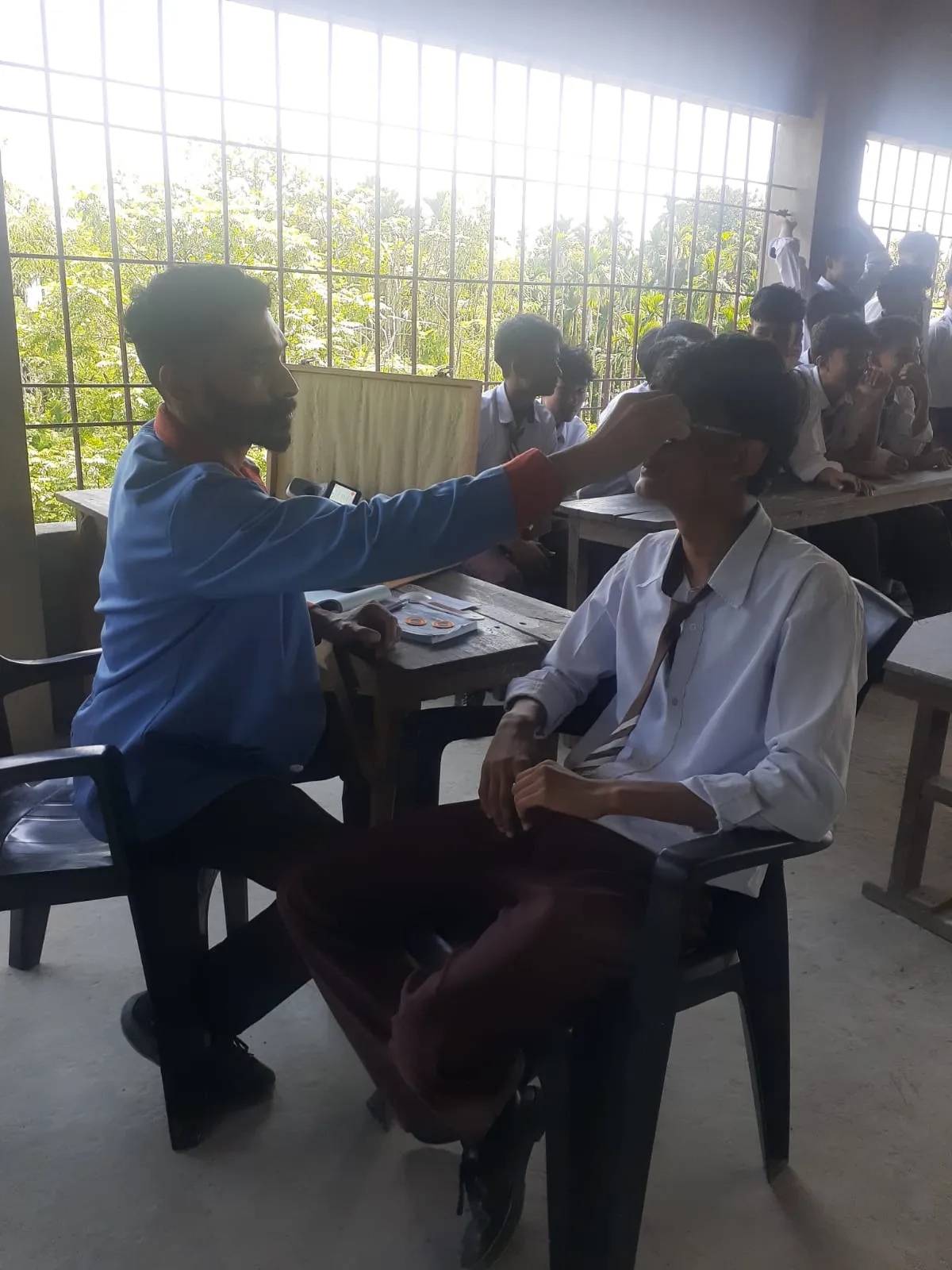 Vision screening coordinator scheduling transport for referred cataract patients.